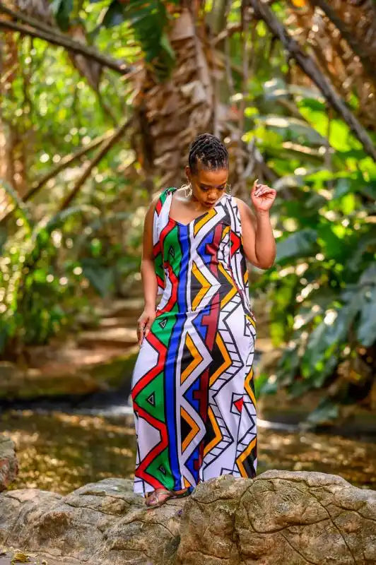 Colorful geometric-patterned sleeveless maxi dress with bold zigzag designs in red, blue, white and green.