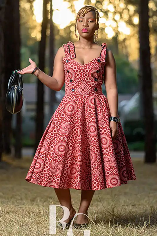 A sleeveless fit-and-flare dress in red and white circular African print fabric.