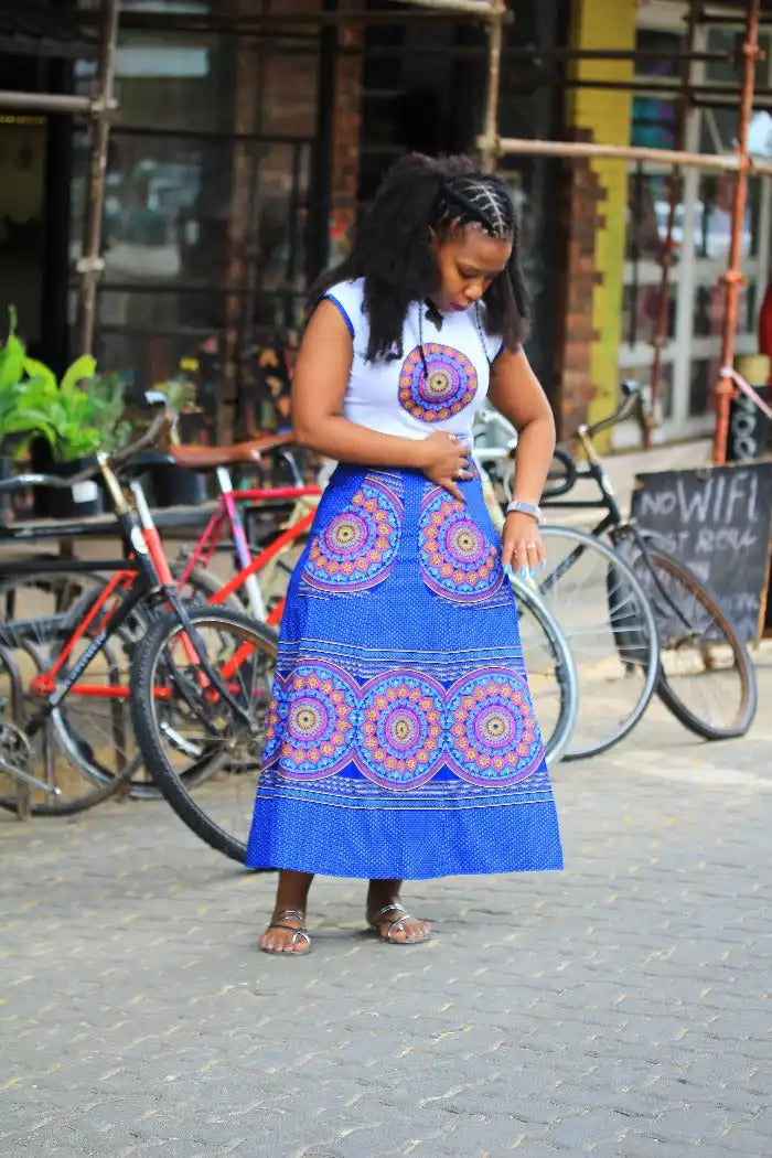 Vibrant blue and orange patterned maxi skirt paired with a white sleeveless top.